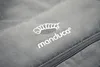 A close-up of a grey fabric with a white embroidered logo and text. Produktbild-Vorschau