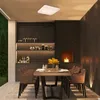 An outdoor dining area with a table set for a meal, a fireplace, and shelves with kitchenware. Produktbild-Vorschau