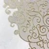 A close-up view of a white and gold patterned fabric. Produktbild-Vorschau