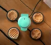 A mini waffle maker with interchangeable plates and four finished waffles on a wooden table. Podgląd zdjęcia produktu