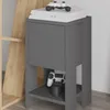A modern gray nightstand with a gaming console and controller on top and a controller in the lower shelf. Anteprima dell’immagine prodotto