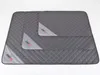 Three quilted gray dog mats of different sizes are stacked on a white background. Voir les images du produit