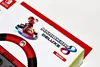 A close-up of the packaging for the Mario Kart 8 Deluxe Racing Wheel for Nintendo Switch, featuring Mario in his kart. Podgląd zdjęcia produktu