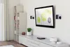A modern living room with a TV mounted on the wall, a bookshelf, and a media console. Podgląd zdjęcia produktu