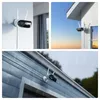 Collage of three images showing a white security camera with two antennas mounted on different exterior surfaces, including a wall, a house corner, and under a gutter during rain. Produktbild-Vorschau