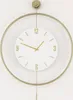 A close-up shot of a modern wall clock with a gold frame and a white face. Náhľad obrázku produktu