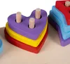 A close-up of a wooden sorting toy with heart-shaped pieces stacked on pegs. Náhled obrázku produktu
