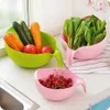 Three colanders filled with produce are arranged on a kitchen counter next to a sink. Produktbild-Vorschau