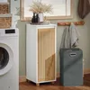 A laundry room scene with a washing machine, a tall white cabinet with wooden slats, and a gray laundry basket. Anteprima dell’immagine prodotto
