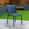 A blue chair sits on a patio in a garden setting with artificial grass and planters. Produktbild-Vorschau