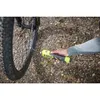 A person is using a portable air compressor to inflate a bicycle tire outdoors on a gravel path. Produktbild-Vorschau
