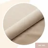 A close-up view of a rolled-up piece of fabric, likely upholstery material, with a label indicating a product code. Anteprima dell’immagine prodotto