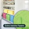A cabinet with shelves filled with jars and folded microfiber cloths in various colors. A close-up of green microfiber cloths is shown in a circular inset. Produktbild-Vorschau