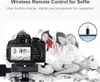 A DSLR camera is set up on a tripod, with a group of young women posing for a selfie in the background. A small inset image shows a remote control. Náhľad obrázku produktu