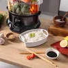 A steaming appliance with food and rice on a wooden table. Náhled obrázku produktu