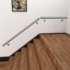 A stainless steel handrail is installed along a staircase with wooden steps. Produktbild-Vorschau
