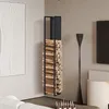 A modern living room with a black metal firewood rack filled with logs, mounted on the wall. Náhľad obrázku produktu
