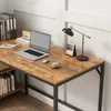 A close-up view of a vintage-style computer desk with a laptop, lamp, and books. Podgląd zdjęcia produktu