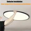 A person is installing a round LED ceiling light. Náhled obrázku produktu