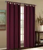 Two burgundy curtains are hanging in front of a window, with a small table and decorative items to the right. Produktbild-Vorschau