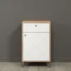 A modern white and wood dresser with black legs against a gray wall. Voir les images du produit