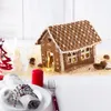 A Christmas-themed table setting with a gingerbread house as a centerpiece. Voir les images du produit