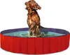 A dog jumping into a red and blue dog pool. Anteprima dell’immagine prodotto
