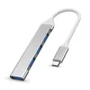A silver USB C hub with four USB 3.0 ports and a USB C connector, shown against a white background. Produktbild-Vorschau