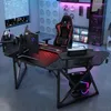A gaming desk setup with a computer, monitor, and gaming chair in a room with ambient lighting. Produktbild-Vorschau