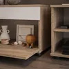 A close-up view of a modern furniture unit, showing decorative items on a shelf and a drawer partially open. Produktbild-Vorschau
