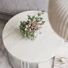 A bouquet of pink roses and greenery sits on a round marble coffee table. Náhľad obrázku produktu
