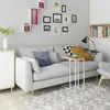 A living room scene with a sofa, side table, and wall decor. Produktbild-Vorschau