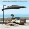 An outdoor patio scene with a large cantilever umbrella, a sofa, and a coffee table, overlooking the ocean. Náhled obrázku produktu