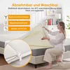 A woman is demonstrating the removable and washable cover of a mattress topper. Produktbild-Vorschau