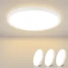 A white, circular LED ceiling light is shown mounted on a ceiling, with three smaller, identical lights displayed in the foreground against a gradient background. Produktbild-Vorschau