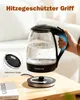 A glass electric kettle is shown on a wooden table, with a hand holding its handle. A power base is also visible. Produktbild-Vorschau