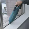 A person is using a cordless vacuum cleaner to clean a window sill. Podgląd zdjęcia produktu