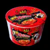 A product shot of a cup of Samyang Buldak Ramyun 2x spicy instant noodles against a black background. Produktbild-Vorschau