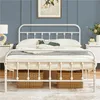 A white metal bed frame is shown in a bedroom setting with a blue wall and bedside tables. Produktbild-Vorschau