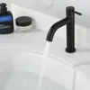 A black faucet in a bathroom sink with water running. Produktbild-Vorschau