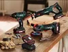 A collection of cordless power tools, including a reciprocating saw, impact driver, and angle grinder, are displayed on a wooden workbench. Produktbild-Vorschau