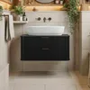 A modern black vanity cabinet with a white vessel sink mounted on a tiled wall. Anteprima dell’immagine prodotto