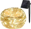 A coiled string of solar-powered LED lights with a solar panel on a stake. Podgląd zdjęcia produktu