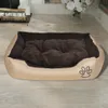 A dog bed is placed on a wooden floor in front of a fireplace. Náhľad obrázku produktu