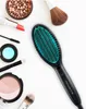 A collection of makeup and a hair straightening brush arranged on a white background. Produktbild-Vorschau
