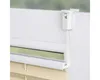 A close-up view of a white window blind mechanism and part of the blind itself. Produktbild-Vorschau
