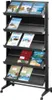 A black multi-tiered display rack for brochures or magazines, shown against a white background. Voir les images du produit