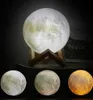 A main moon lamp with three smaller moon lamps below it, each with a different color. Produktbild-Vorschau