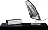 A silver electronic device and a model windsurfing sail are displayed on a black shelf against a white background. Náhled obrázku produktu