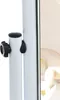 A close-up of a white stand with a black knob and a black teardrop-shaped lever. A blurred background shows a cream-colored chair. Podgląd zdjęcia produktu